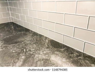 Staggered Glass Tiles Designed And Installed As A Kitchen Counter Top Backsplash