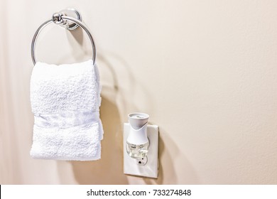 Staging modern bathroom with one small white towel hanging on rack in model home, apartment or house with air freshener