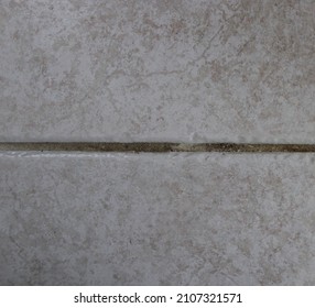 Stained Dirty Grout Between A Tiled Floor