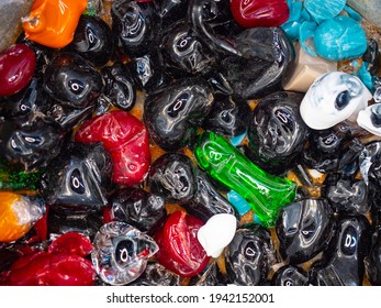 Stained Glass Shards And Waste In A Glass Studio Container. The Hot Glass Is Cut With Special Scissors Into The Vessels, Where It Burns And Cracks