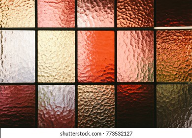 Stained glass window pane in red/orange hue