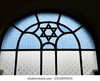 A stained glass window in a Singapore synagogue features a Star of David in blue and white glass as an architectural feature.