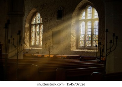Stained glass window with sun rays pouring in.