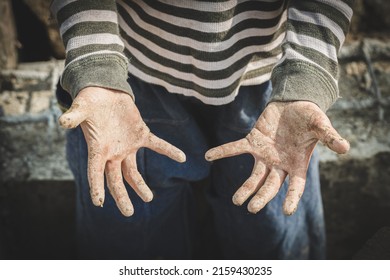 Stained hands are forced to work. The concept of anti-child labor. The abuse of labor. The oppression or intimidation of forced labor among children. - Shutterstock ID 2159430235