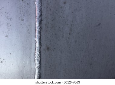 Stained steel plate with weld seam, industrial background texture