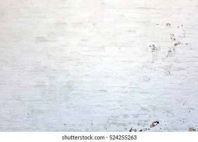 Stained Uneven Old Stucco Brick Wall. Aged Light White Grey Chalk Paint Brickwall Background. Rustic Outdoor White Washed Plastered Wall. White Concrete Wall Shabby Empty Background Or Texture