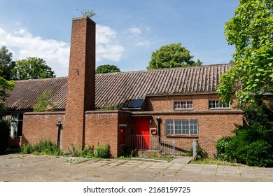 Staines-upon-Thames, UK  June 15th 2022  Rear Entrance And Courtyard Of A 1930's Interwar, Brick Built Church Hall With Chimney Stack. Film Location For Netflix Series Straight Shooter 