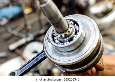 Stainless ball bearing on drive shaft. Shallow depth of field with only parts of the bearing in focus. - Shutterstock ID 665208346