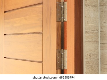 Stainless door hinges on wooden swing door
