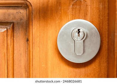 Stainless keyhole on wooden door - Powered by Shutterstock