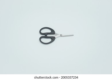 A Stainless Steal Scissor With Black Handle