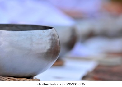 stainless steel alms bowl in a temple ordination ceremony in India - Shutterstock ID 2253005325