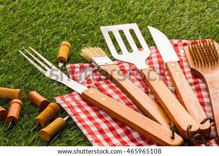 Stainless steel barbecue cooking set with wood handles.