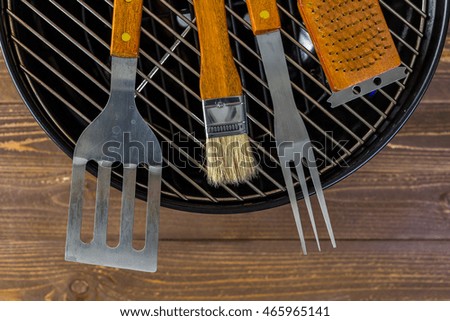 Stainless steel barbecue cooking set with wood handles.