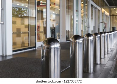 Stainless Steel Bollard Barriers At Entrance Door. Stainless Steel Pole Prevent People For Security