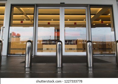 Stainless Steel Bollard Barriers At Entrance Door. Stainless Steel Pole Prevent People For Security