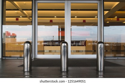 Stainless Steel Bollard Barriers At Entrance Door. Stainless Steel Pole Prevent People For Security