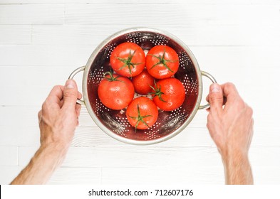 Stainless Steel Colander with Wet Tomatoes in a Chefs Hands After Washing Top View. Cooking Process Concept. Bright Kitchen Background - Powered by Shutterstock