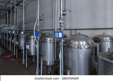 Stainless steel containers - filters are filled with high-quality granular activated carbon. The process of filtering of liquids at food industry facility of alcoholic or soft drinks production.