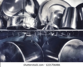 Stainless Steel Cookware Hang On The Wall And Shelves.