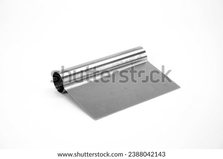 Stainless steel cutter isolated on white background. Stainless steel dough scraper