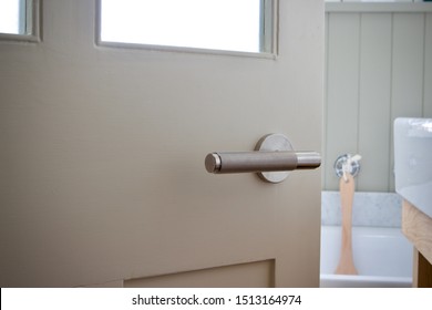 Stainless Steel Door Handle On A Bathroom Door