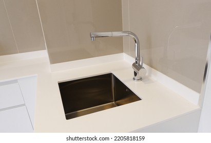 Stainless Steel Faucet On Kitchen White Worktop With Stainless Steel  Sink Under Mount 