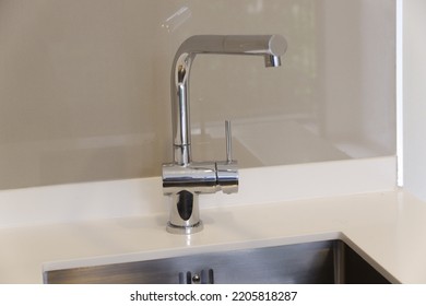 Stainless Steel Faucet On Kitchen White Worktop With Stainless Steel  Sink Under Mount 