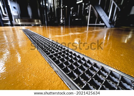 stainless steel floor drain at a modern beer factory