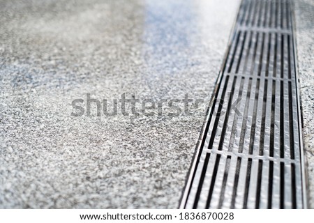 stainless steel floor drain with rain water drop with concrete floor with copy space for text