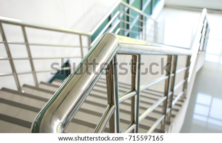 Stainless steel handrail and white stair in office building