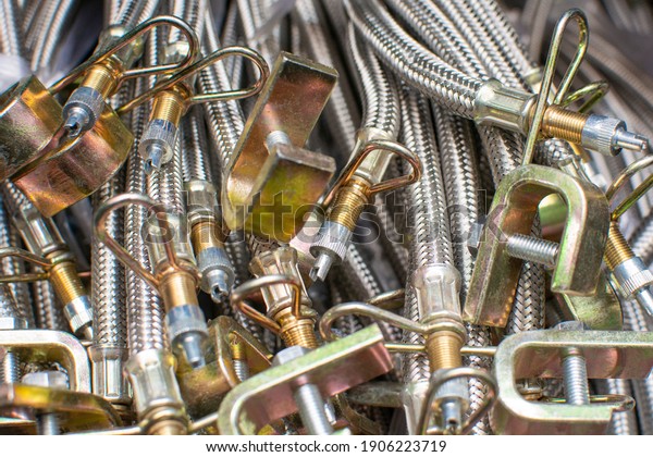 Stainless steel\
hydraulic hoses close up. Brake hoses car, truck, tractor, heavy\
machinery. Industrial\
background.
