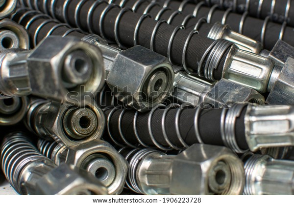 Stainless steel\
hydraulic hoses close up. Brake hoses car, truck, tractor, heavy\
machinery. Industrial\
background.