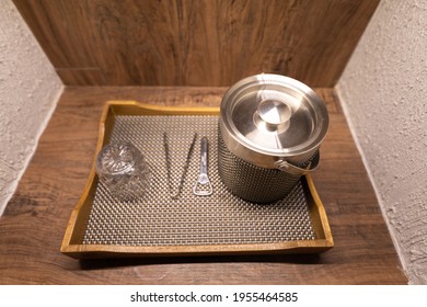 A Stainless Steel Ice Container Box And Drinking Glassware Set Which Is Prepared In Tray, Placed On Wooden Textured Counter. Close-up And Selective Focus At The Cover Part, Drinking Object Photo.