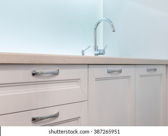 Stainless Steel Kitchen Sink On White Granite Worktop