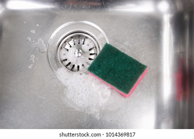 Stainless Steel Kitchen Sink With Soap Suds And Cleaning Sponge