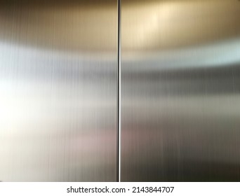 Stainless steel large sheet  With light hitting the surface  For background,Inside passenger elevator,Reflection of light on a shiny metal texture,stainless steel background.
