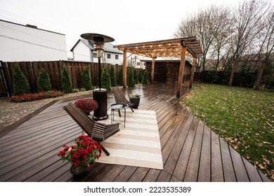 Stainless Steel Metal Gas Outdoor Patio Heater With Wooden Chairs And Pot With Flowers At Wet Terrace. Place To Relax.