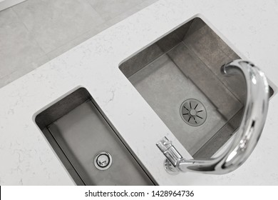 Stainless Steel Mixer Taps And Under Mount Sink With White Quartz Stone Worktop.