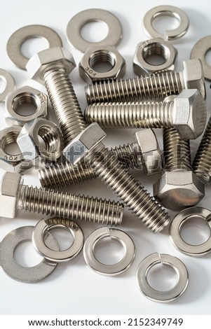 Stainless steel nuts and bolts closeup on white background