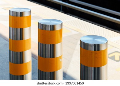 Stainless steel pole prevent people for security. Outdoor stainless steel bollard barriers with yellow line.