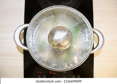 Stainless Steel Pot Boiling Water. A Pan On The Electric Stove. Top View. Kitchen Cooking.