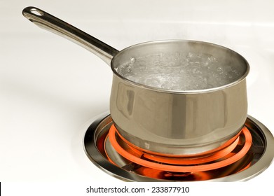 Stainless Steel Pot On Red Hot Electric Burner On Stove