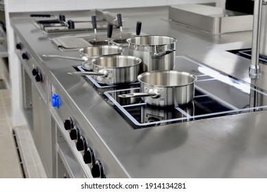 Stainless steel pots built on the stove in the restaurant kitchen