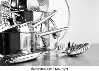 Stainless Steel Pots And Utensils On Table Counter