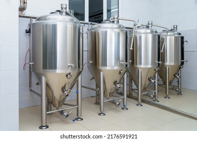 Stainless steel production vats in a brewery or food beverage industry. Background with copy space