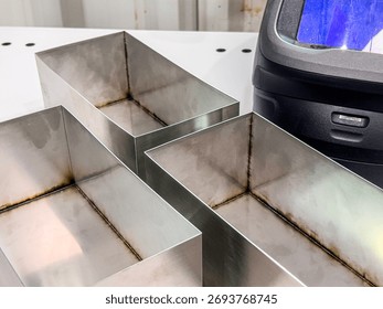 Stainless Steel Rectangular Boxes with Welding Marks in Workshop