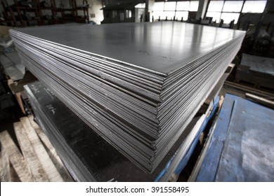 Stainless steel sheets deposited in stacks - Shutterstock ID 391558495