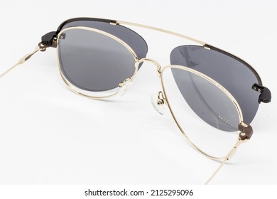 stainless steel sunglasses with clear glass lens There are separate interchangeable black lenses on a white background.