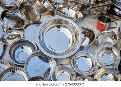 Stainless steel tableware items include plates, bowls, and mugs	